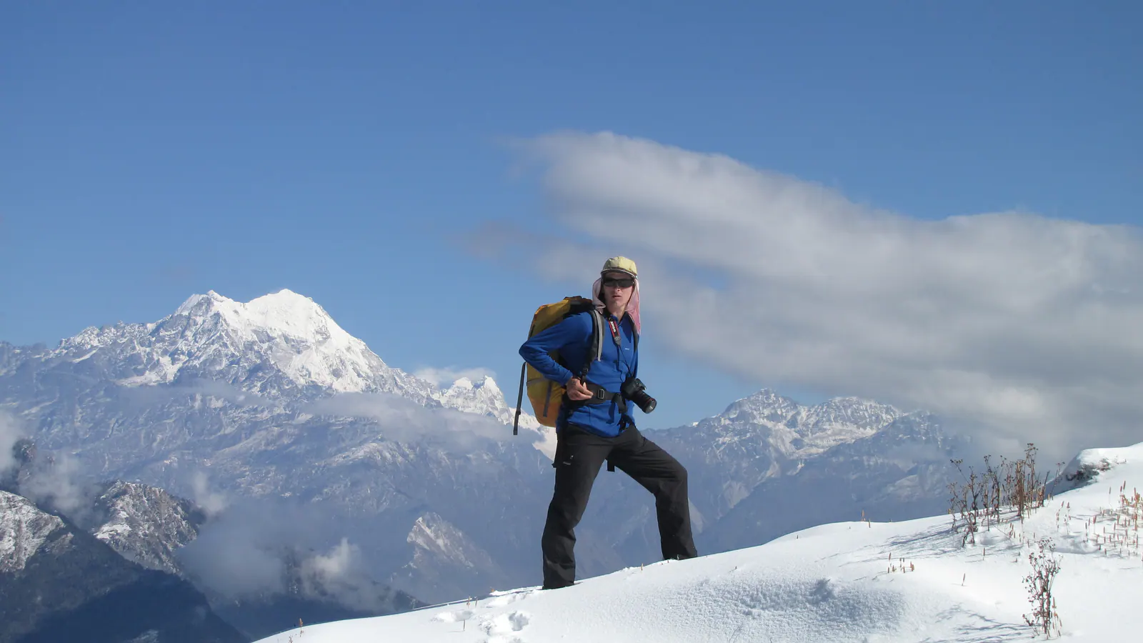 Trekker on a snowy Fikuri ridge with Himalayan mountains behind