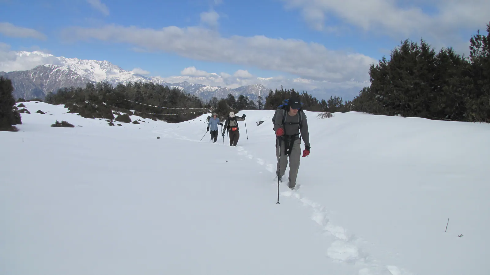 Trekkers crossing deep snow on the Fikuri trail