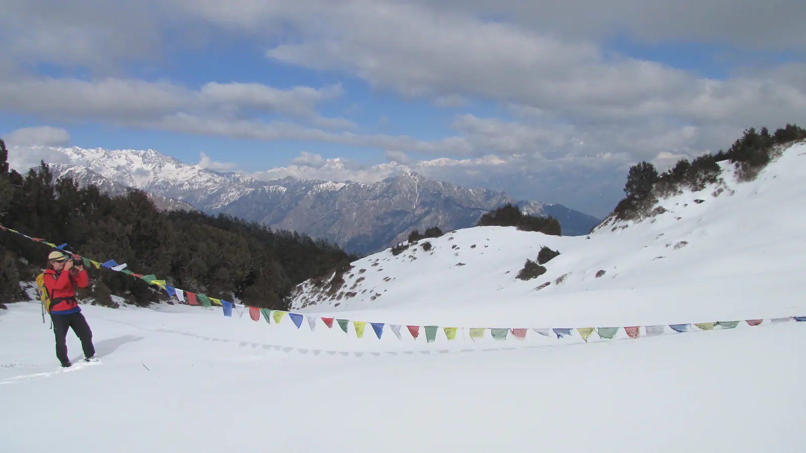 Snowy Fikuri landscape with prayer flags and Himalayan views