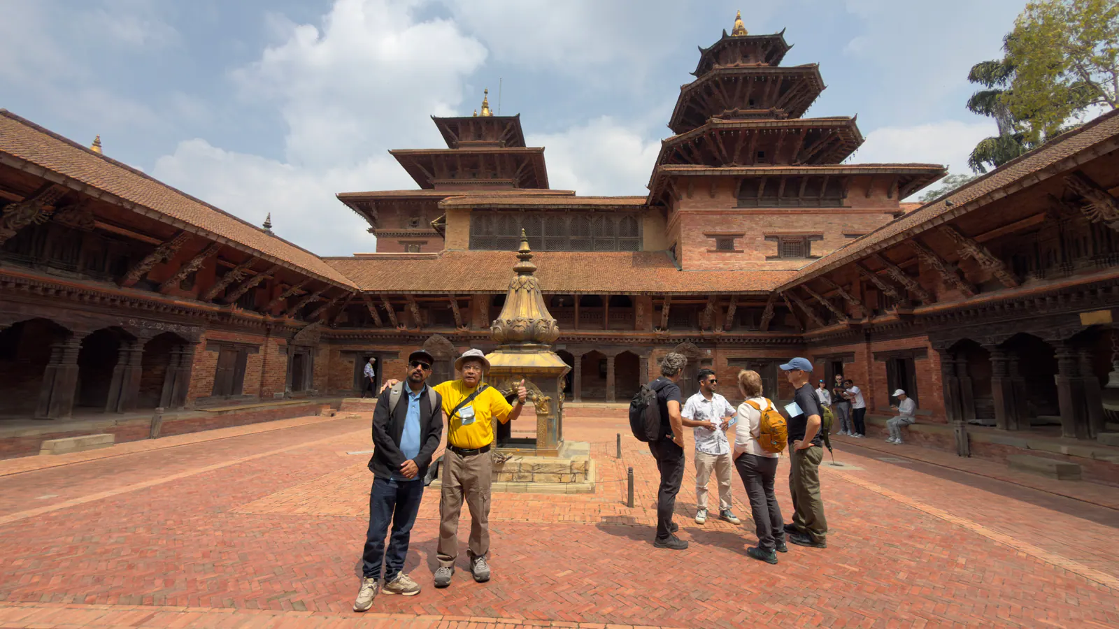 Travelers in the historic courtyard at Patan Durbar Square